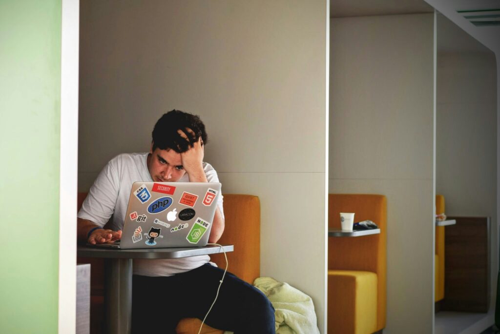 A male student reading something in his laptop
