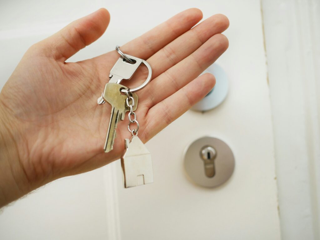 Picture of a hand holding a house key
