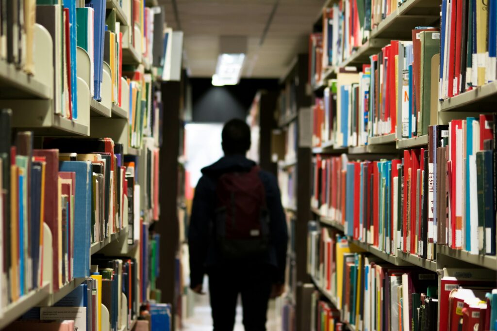 A student walking around in the library