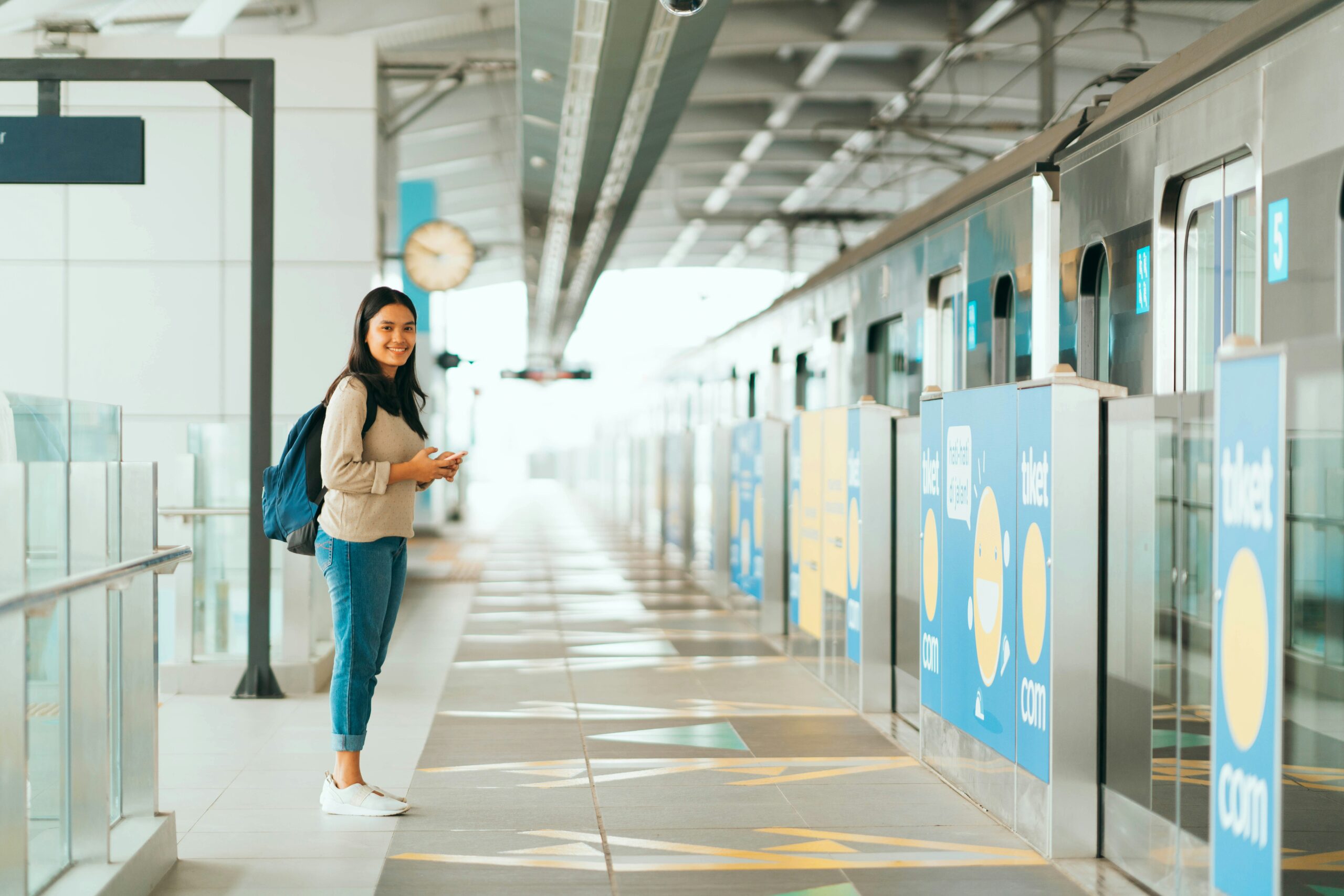 A travelling female student standing in the airport hallway waiting for her turn